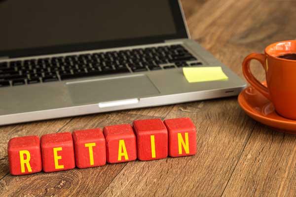 Wooden blocks with letters spell out the word retention