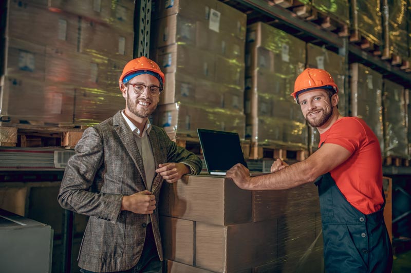 A manager and his employee look happy after having a successful tough conversation with a good outcome