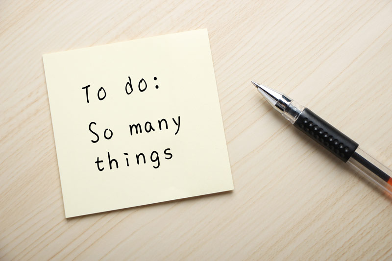 Sticky note with the handwritten reminder to do: so many things