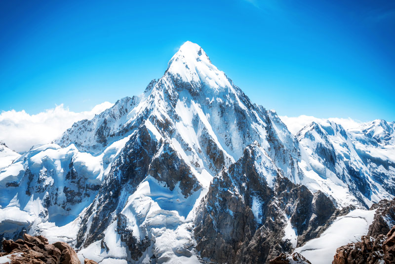 Mount Everest in sunshine to symbolize the challenge of doing difficult things
